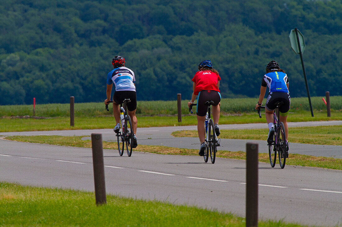 Three cyclists on a country road