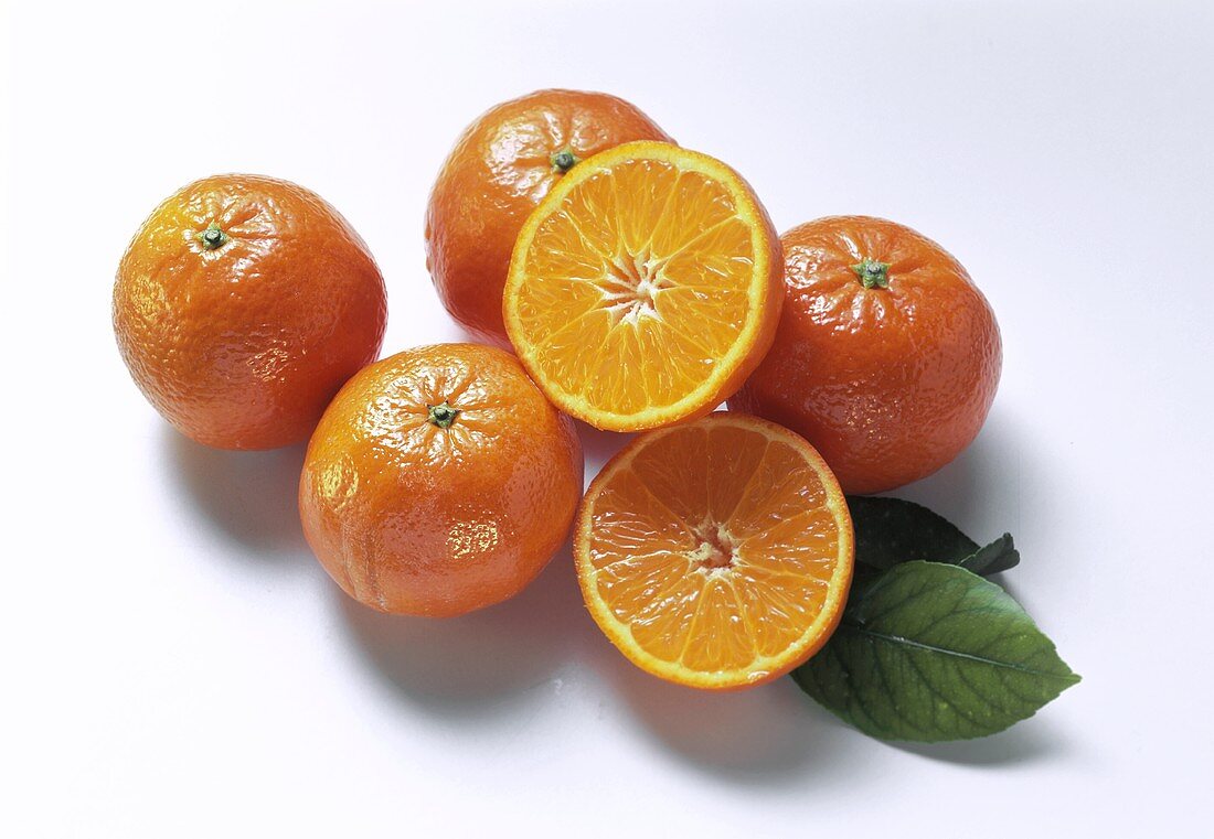 Five Tangerines, One Halved with Leaves