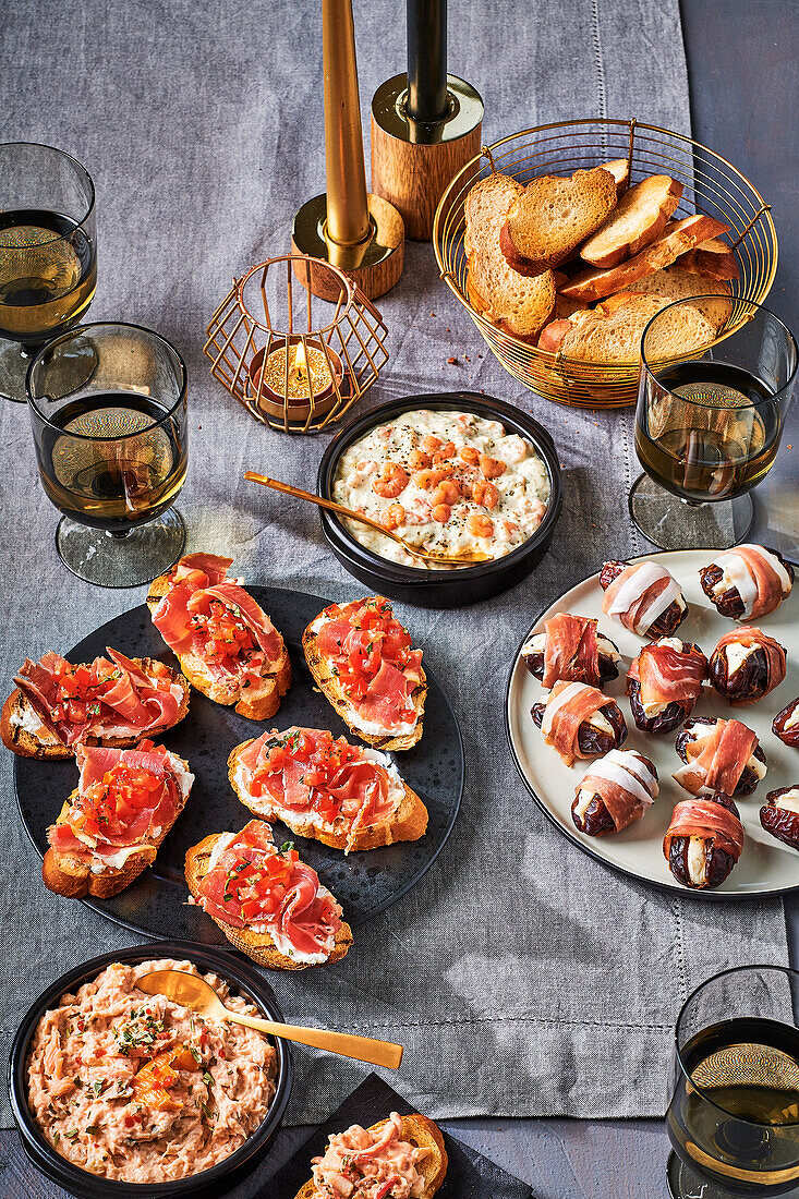 Appetiser buffet with fish salads, bacon dates and Serrano ham