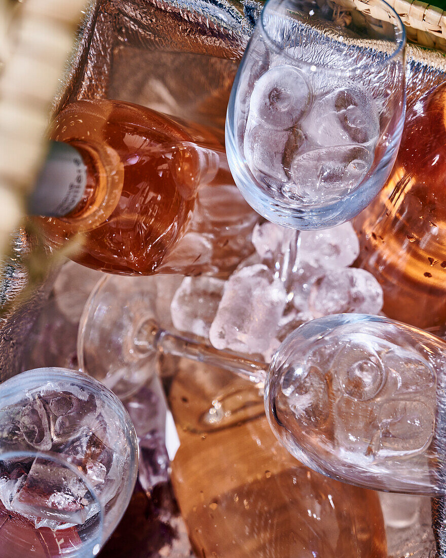 Wine glasses with ice cream and bottle of rosé wine