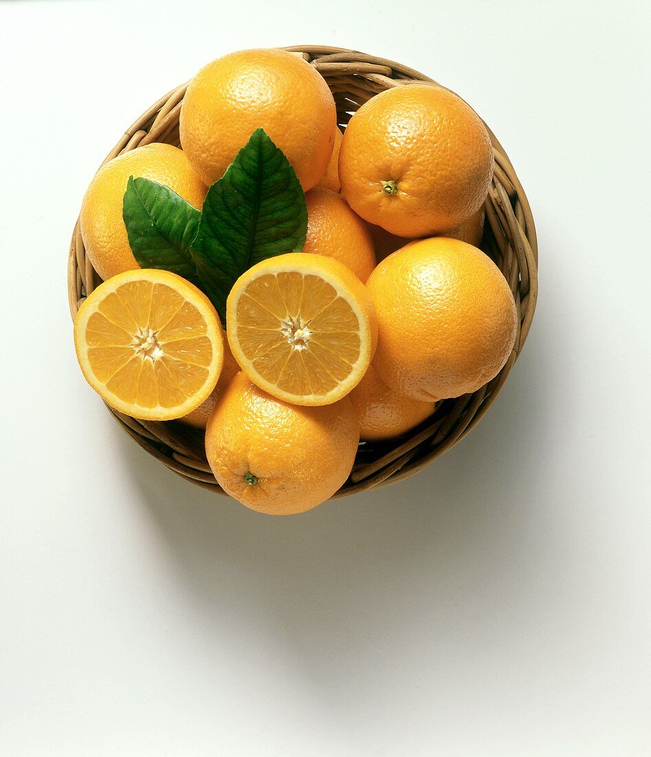 A Basket of Oranges with Leaves
