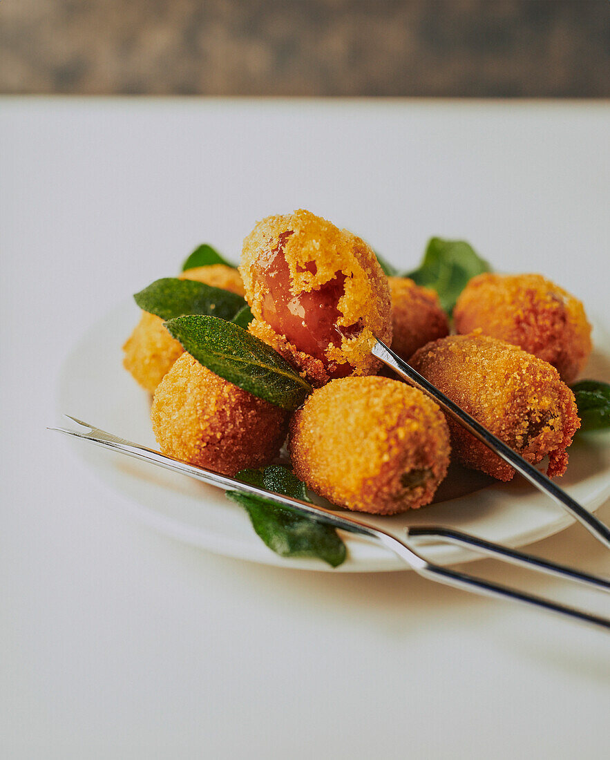 Breaded and deep-fried Greek olives with sage