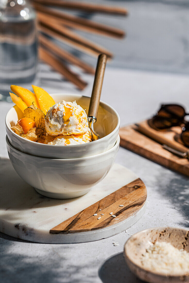 Mango ice cream with fresh fruit and sauce