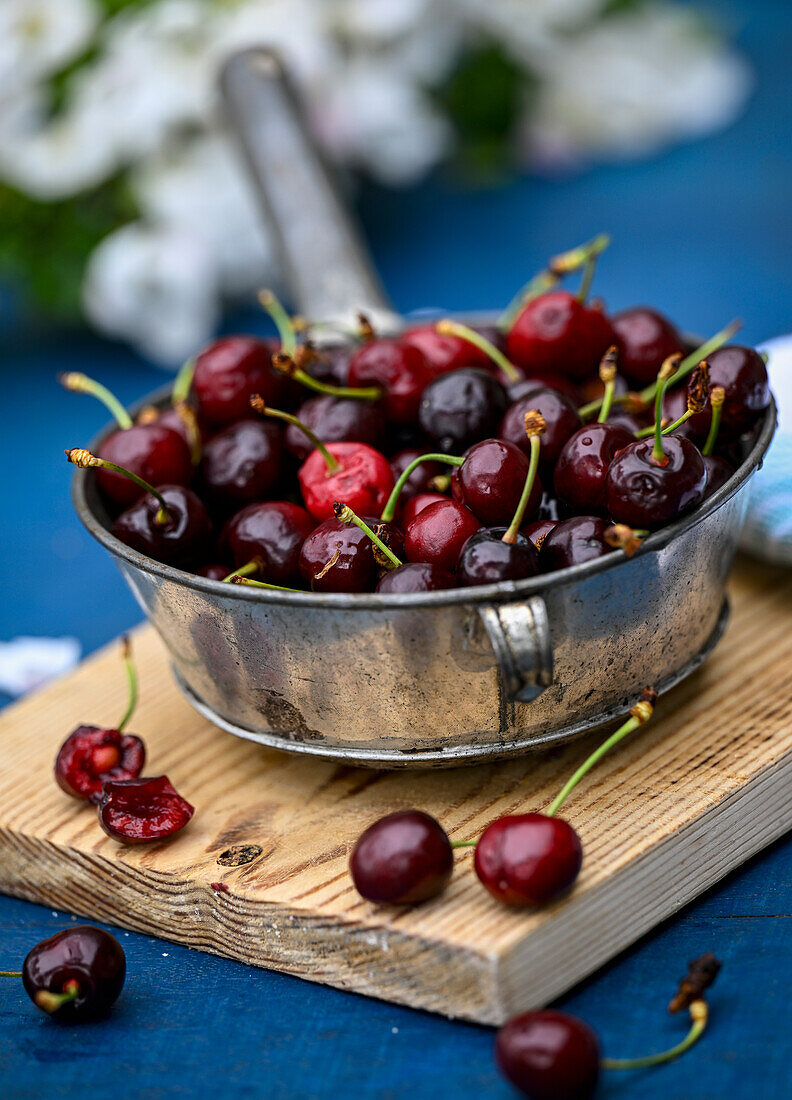 Fresh cherries in a metal bowl