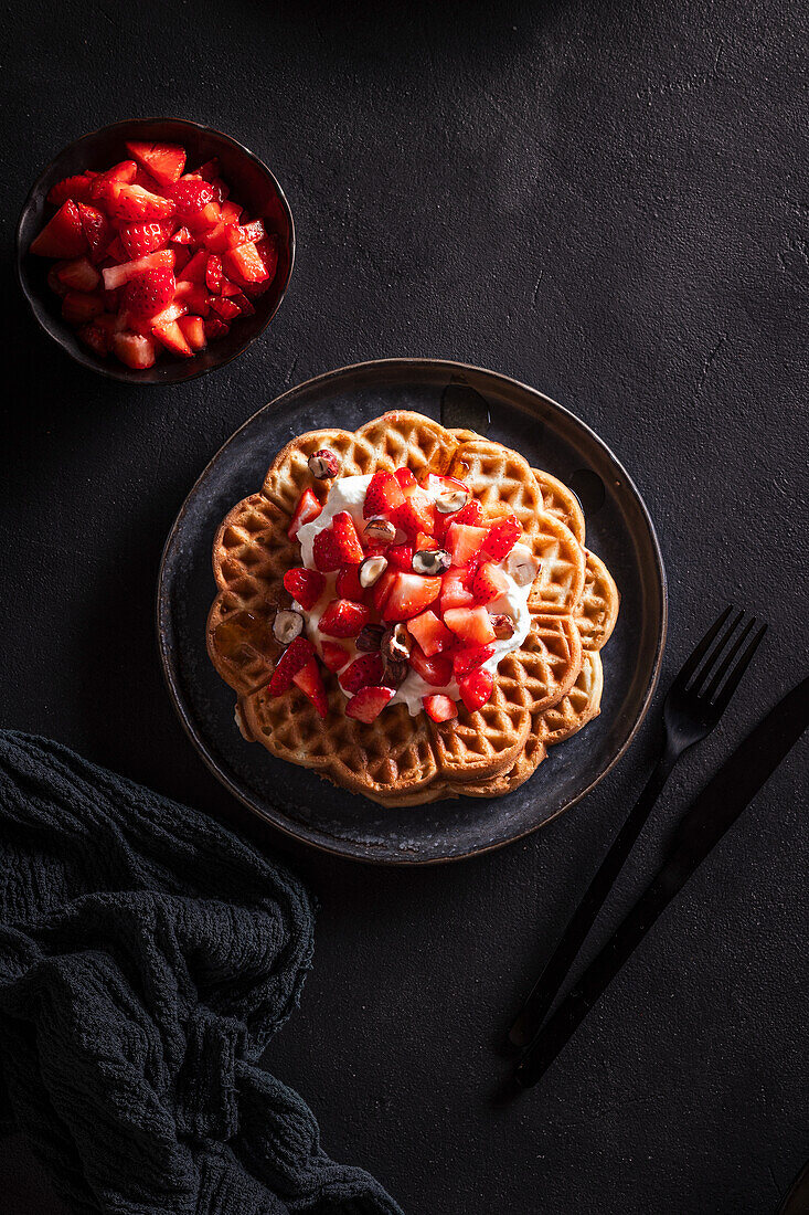 Waffles with whipped cream and strawberries