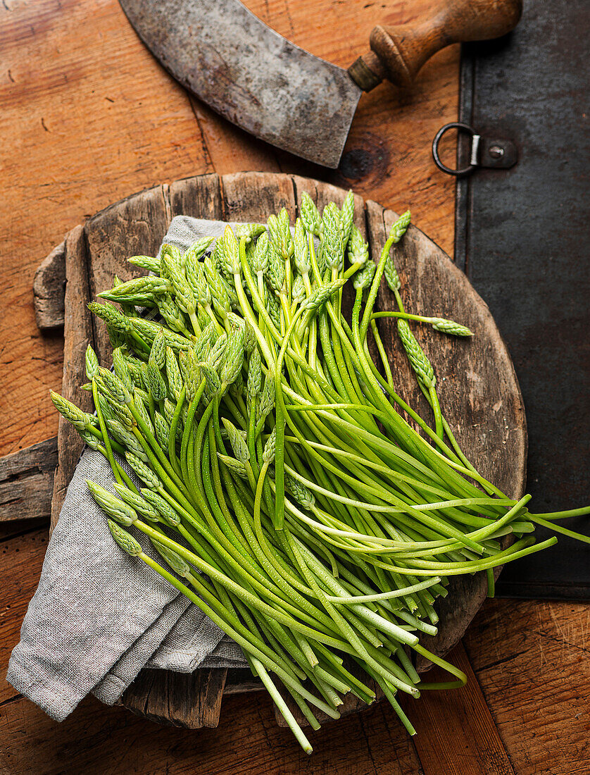 Wild asparagus on a wooden board