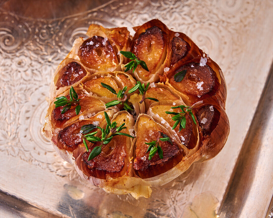 Baked garlic bulb with thyme and sea salt