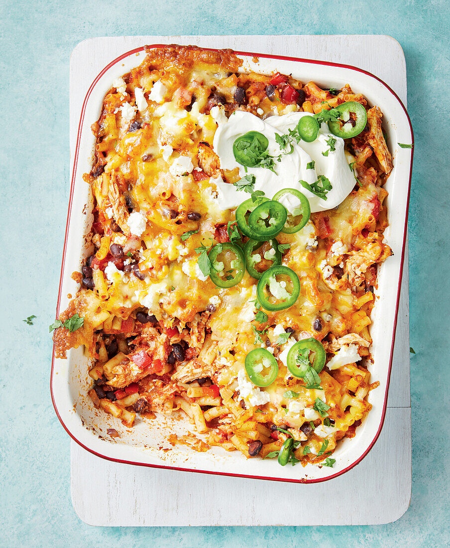 Mexican chicken and pasta casserole with cheese and jalapeños