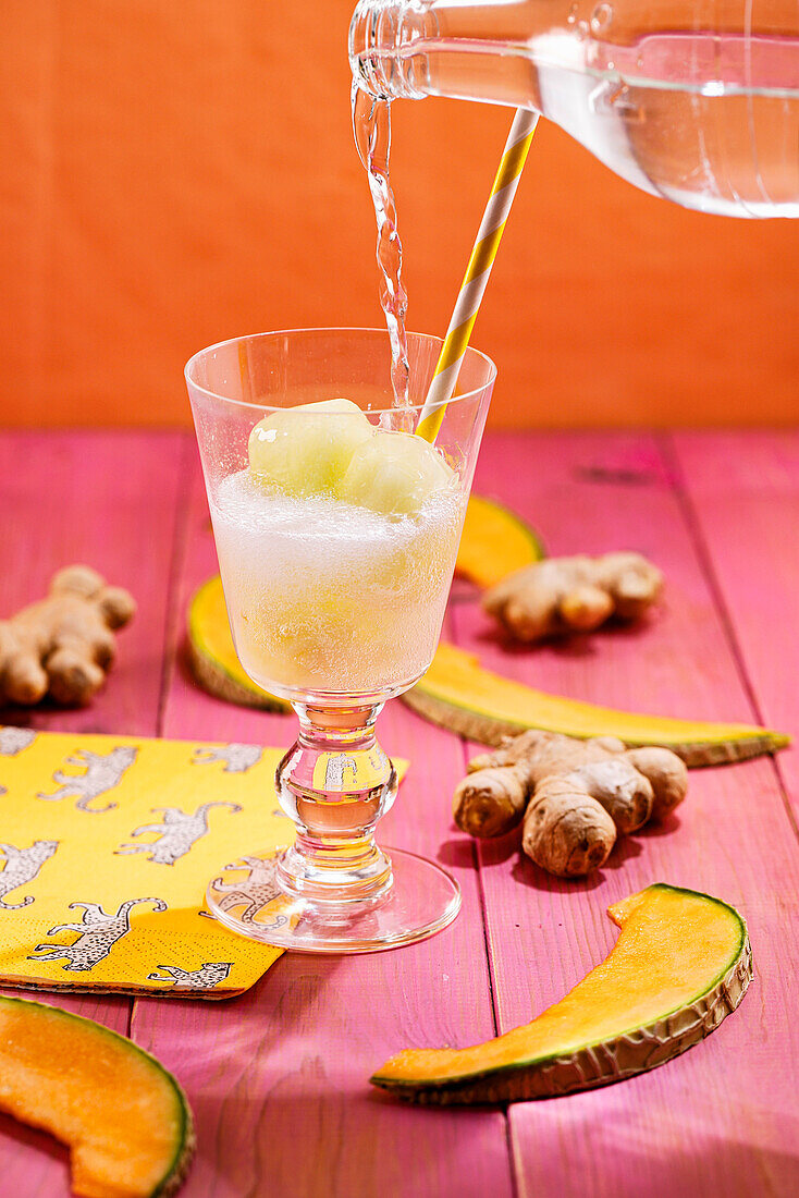 Drink with melon and ginger ice cubes and lemonade