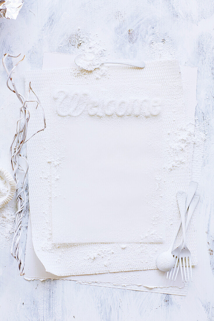 'Welcome' lettering on tea towel dusted with flour