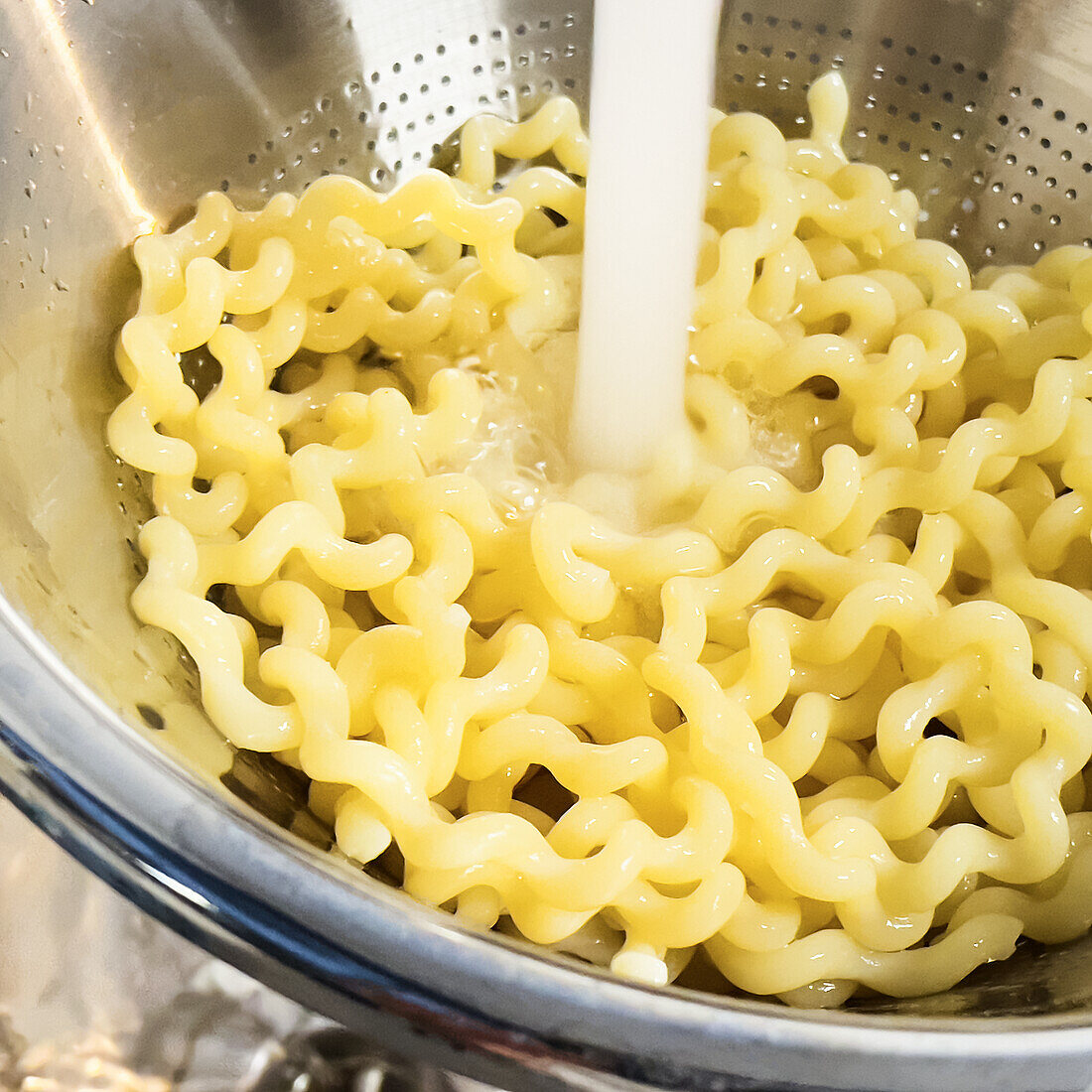 Quench the pasta in a sieve