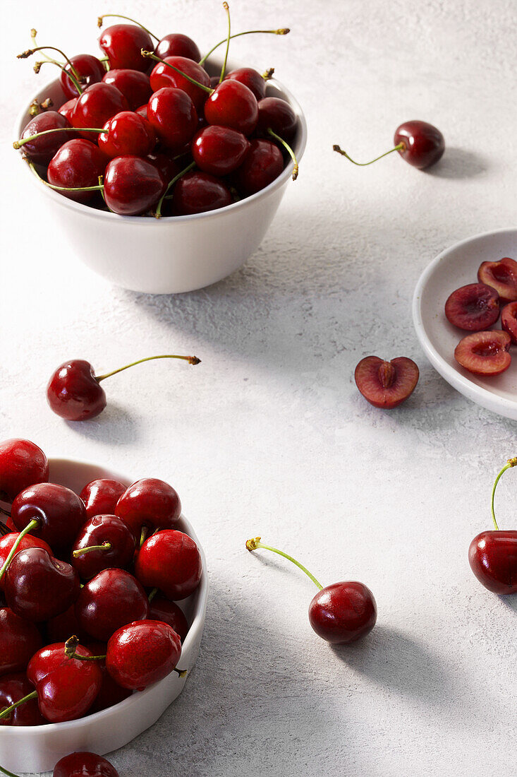 Fresh cherries in small bowls