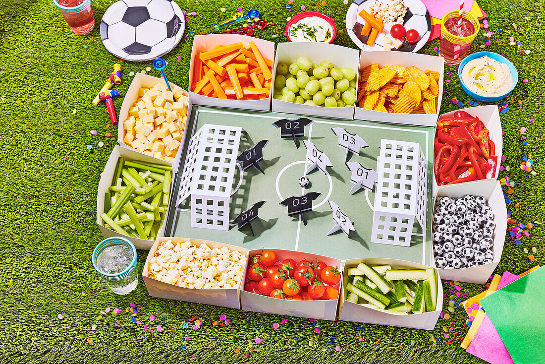 Snack stadium with vegetables, fruit and nibbles