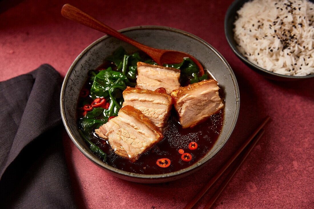 Pork belly in soy sauce with spinach and rice