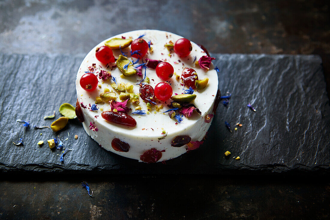 Cranberry cheesecake with pistachios and flowers