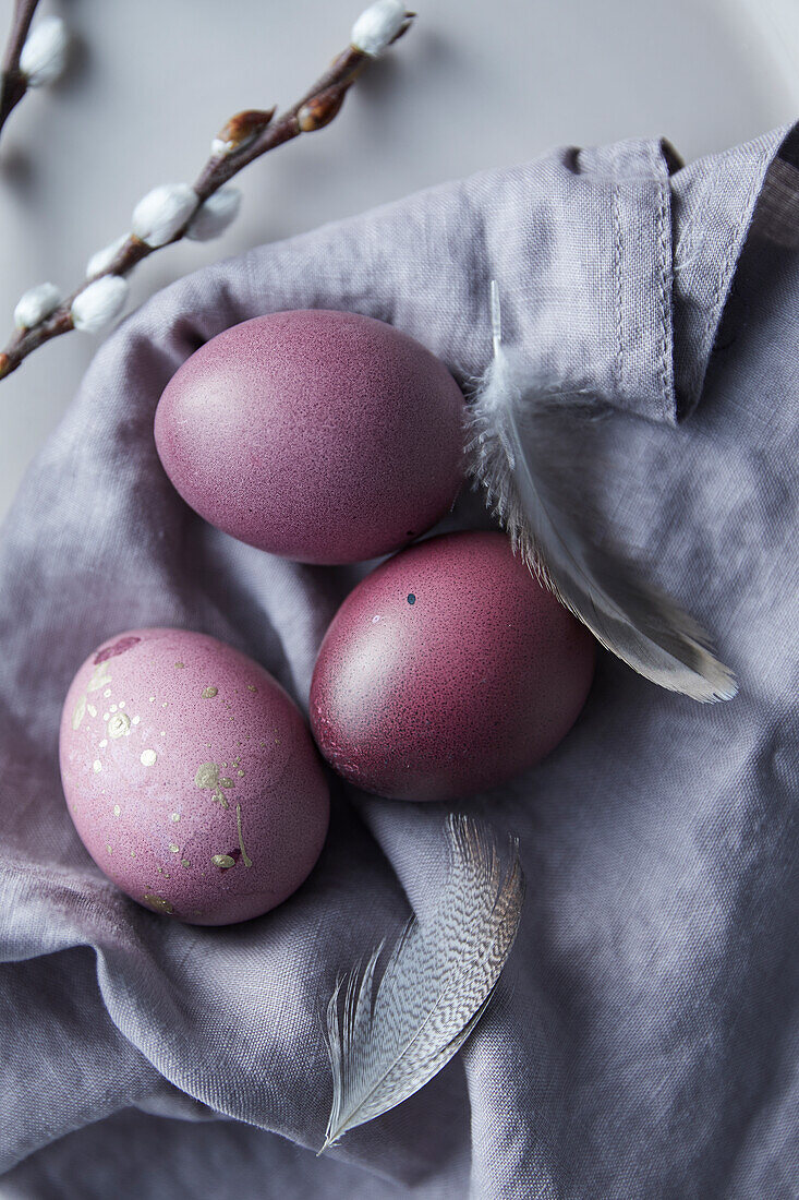 Purple coloured Easter eggs on a cloth napkin