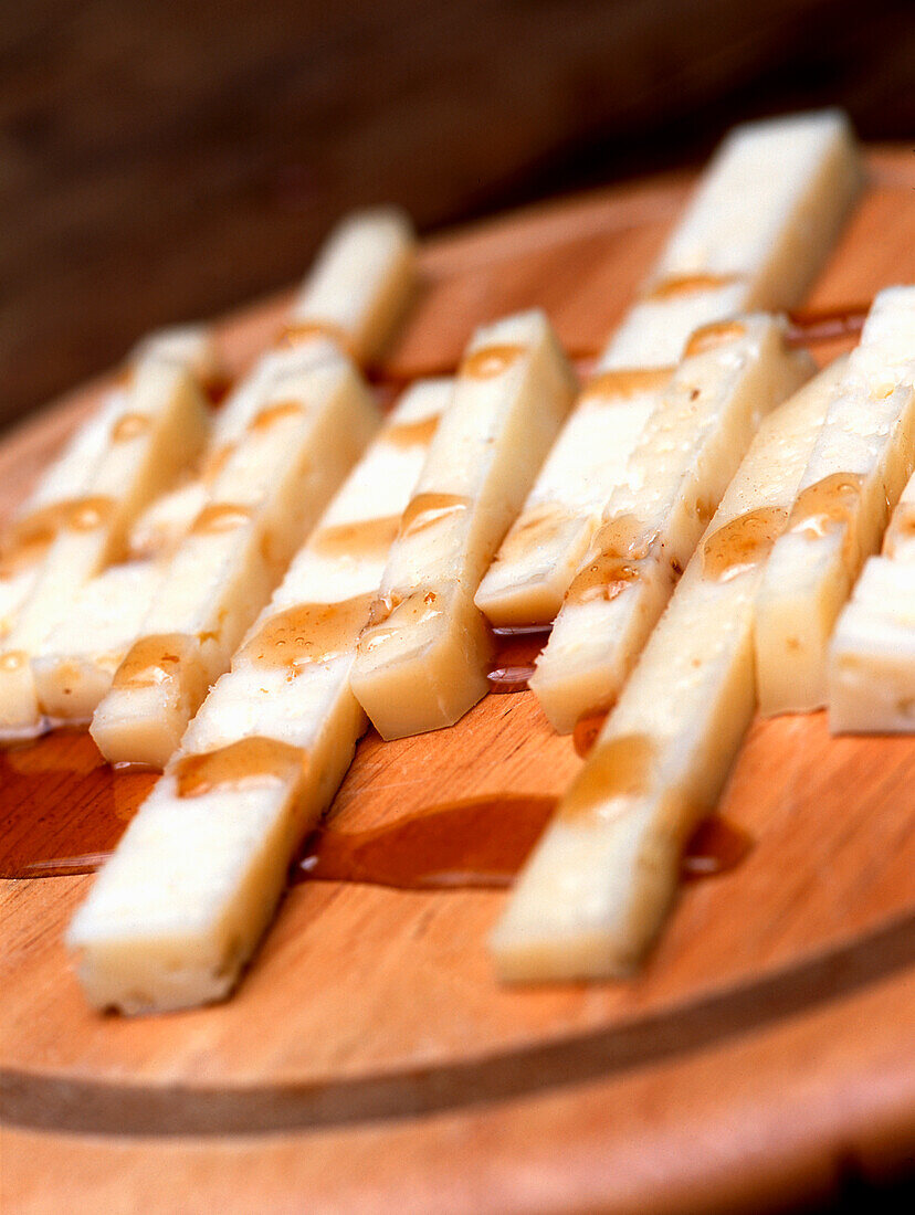 Pecorino with honey on a wooden platter