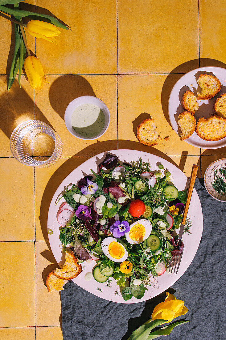 Spring salad with radishes, flowers and egg