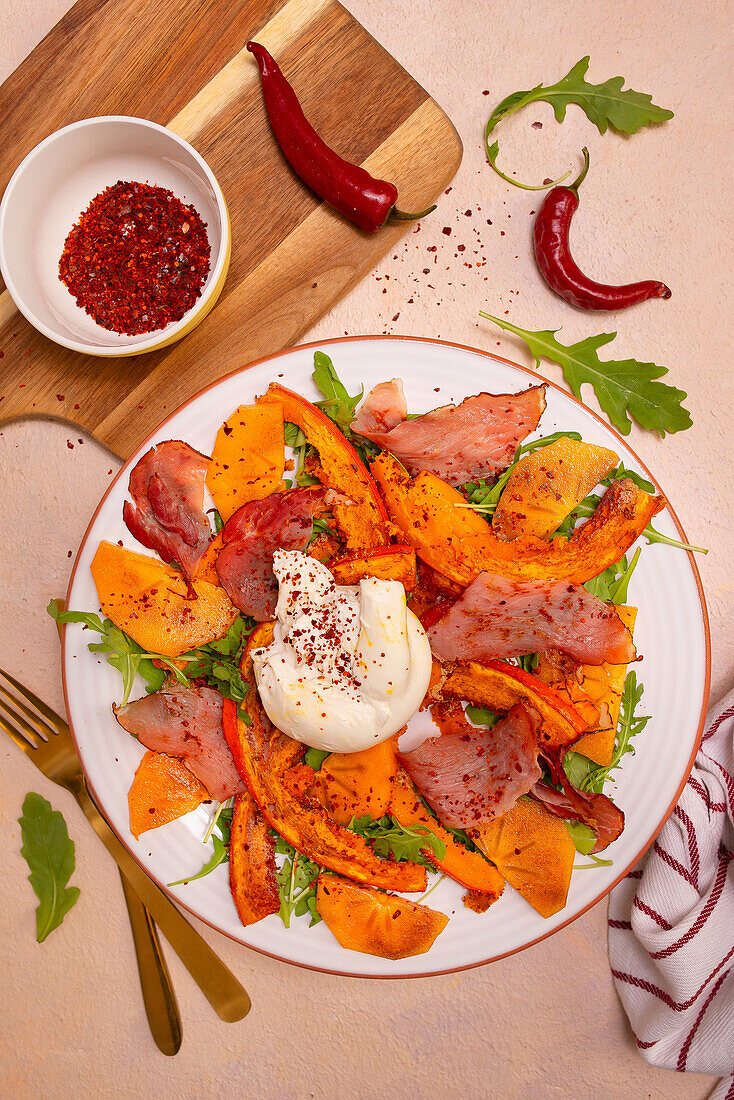 Rocket salad with baked pumpkin, Italian ham, burrata and chilli