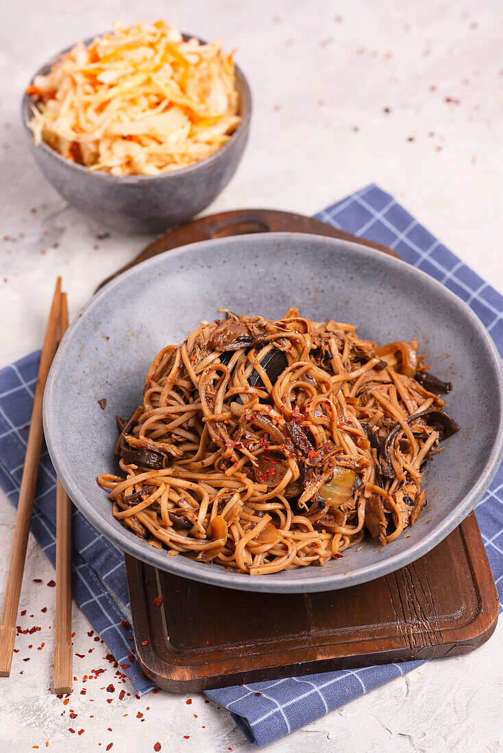 Asian noodles with mushrooms and miso sauce and coleslaw