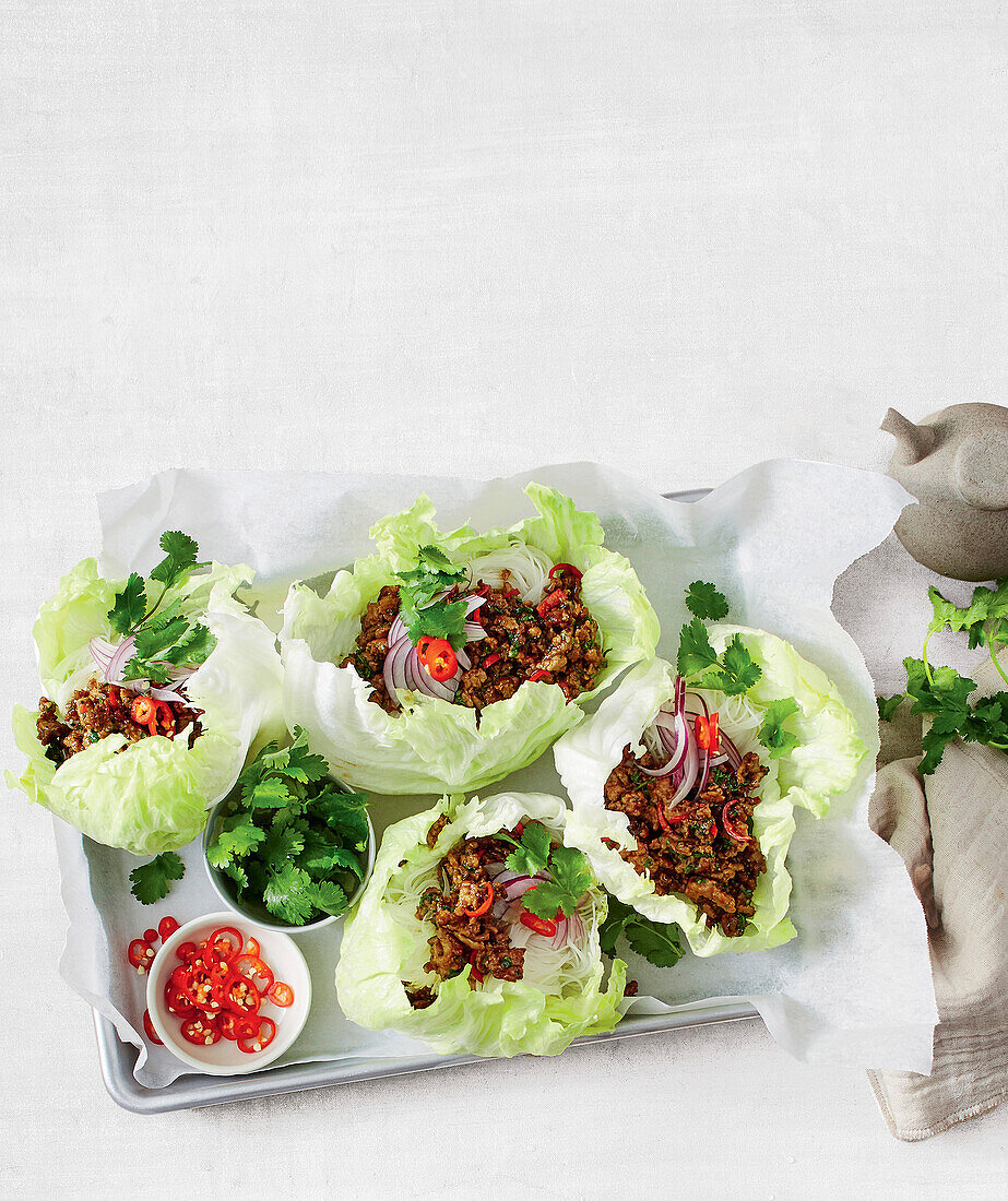 Sticky pork san choy bow in lettuce leaves