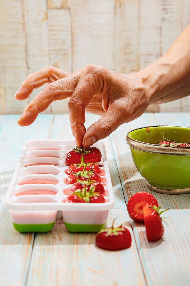 Making strawberry ice cubes