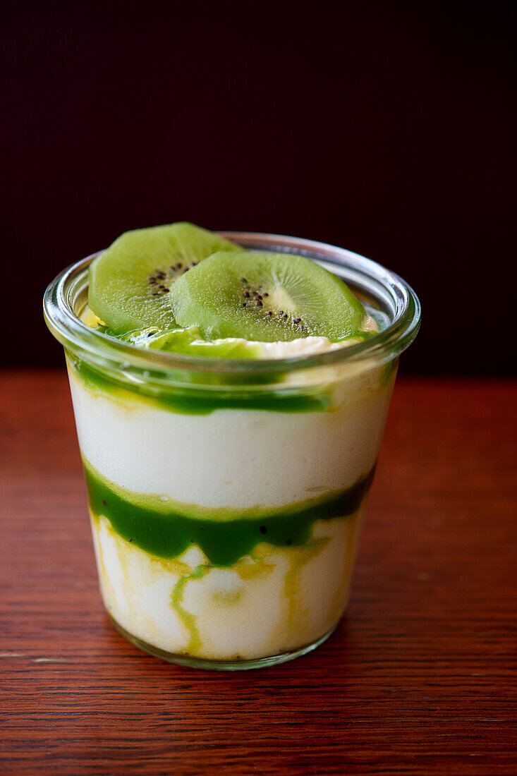 Layered dessert with kiwi and Chantilly in a glass