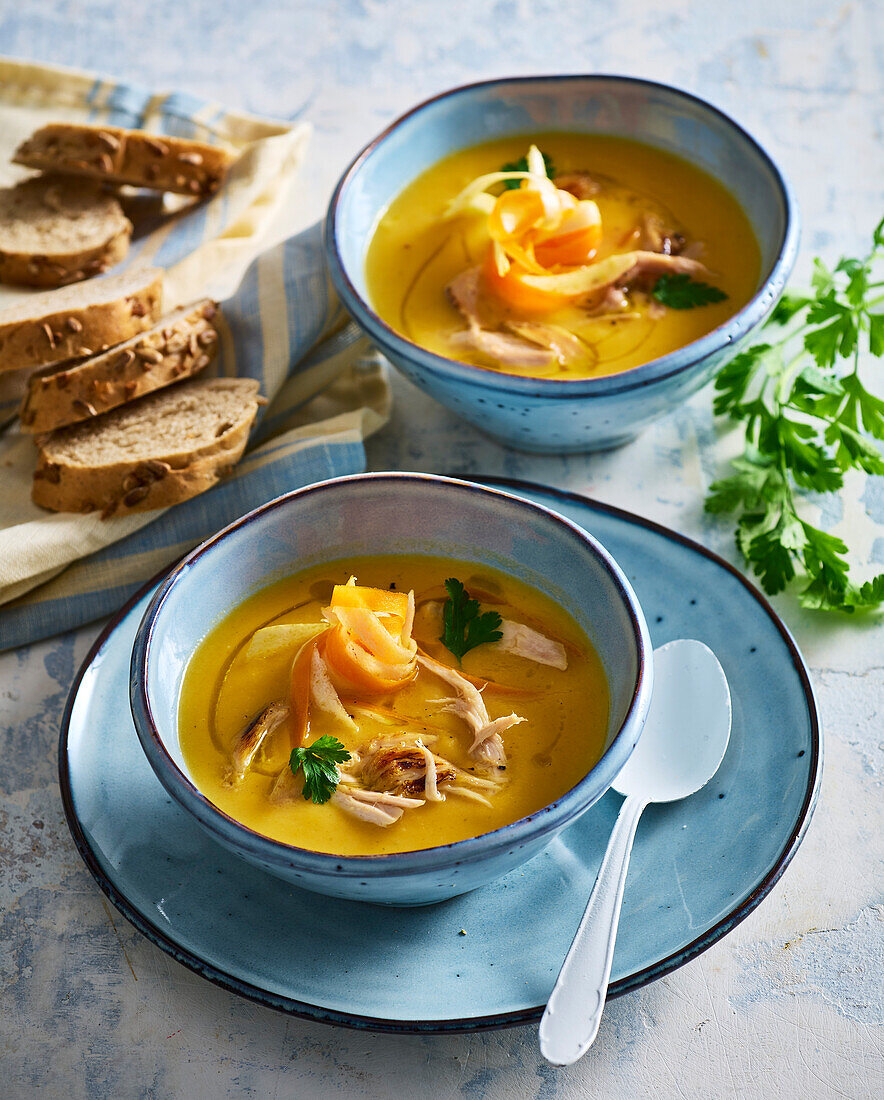 Creamy carrot and chicken soup with fresh herbs