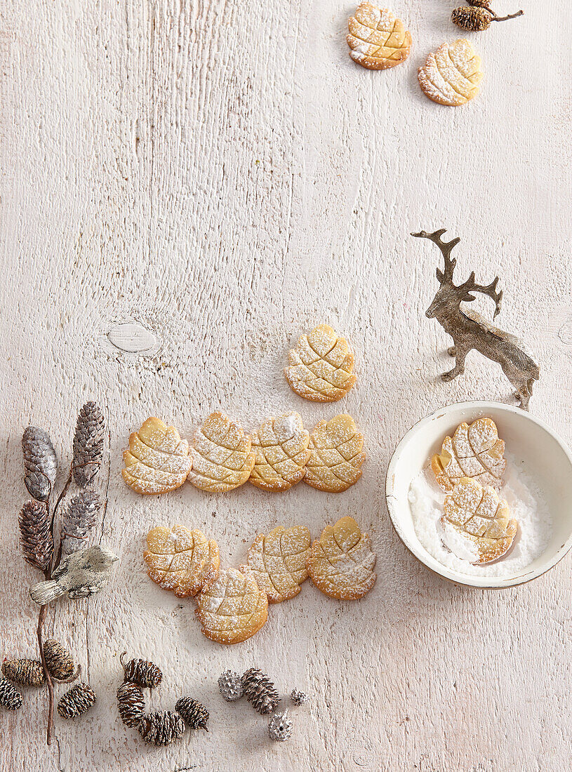 Pine cone-shaped almond biscuits dusted with icing sugar