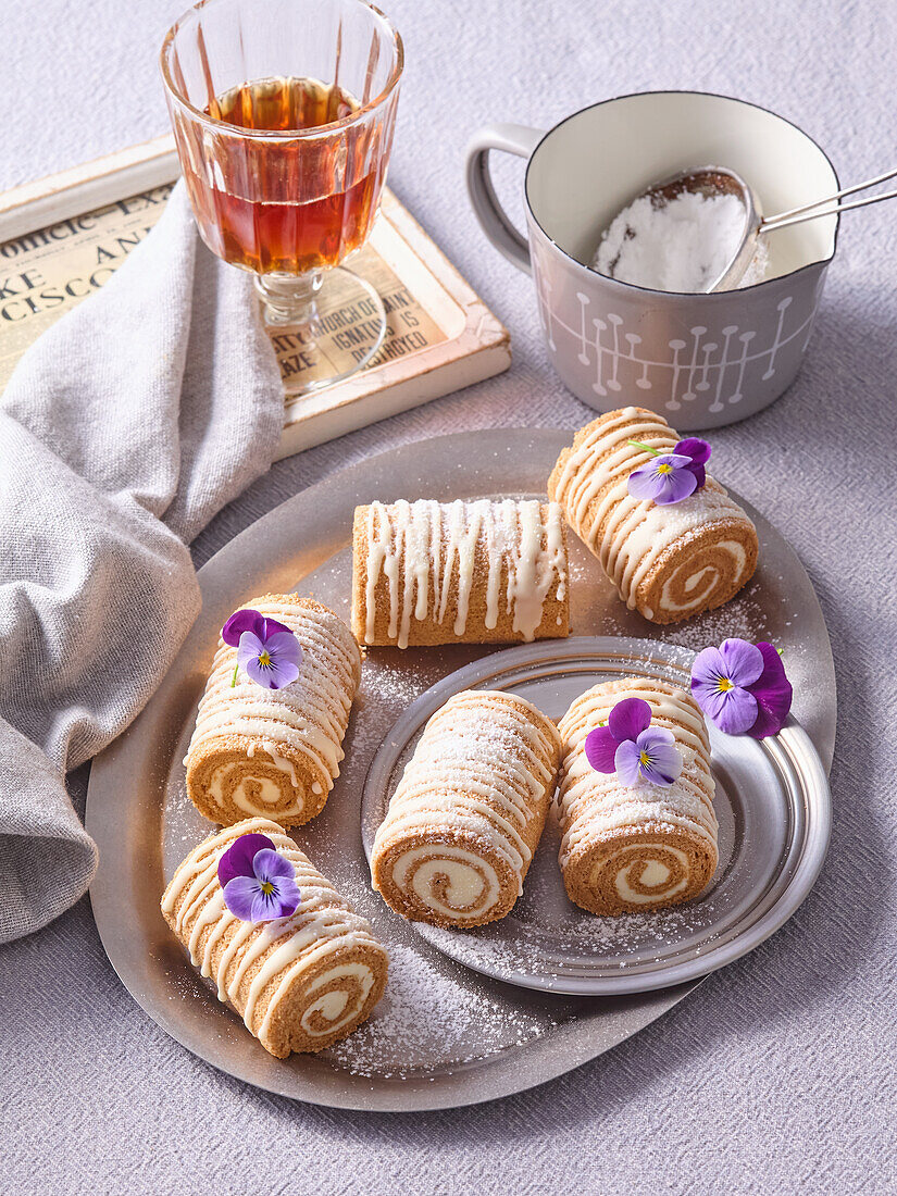 Carrot cake rolls with icing and cinnamon