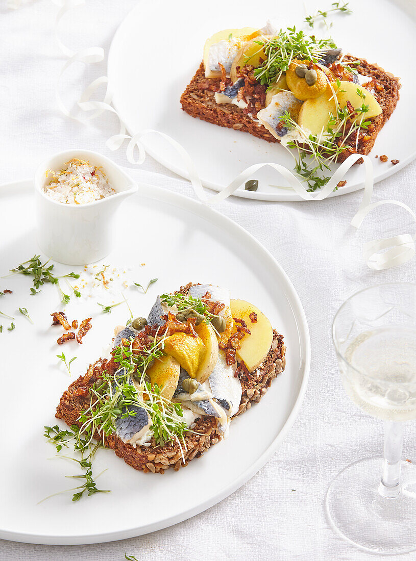 Rye bread with herring, potatoes and cress