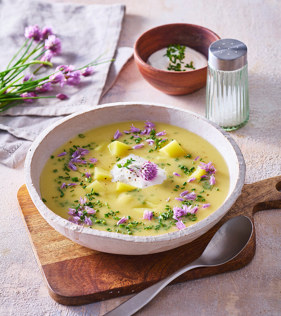 Potato soup with chives and cream topping