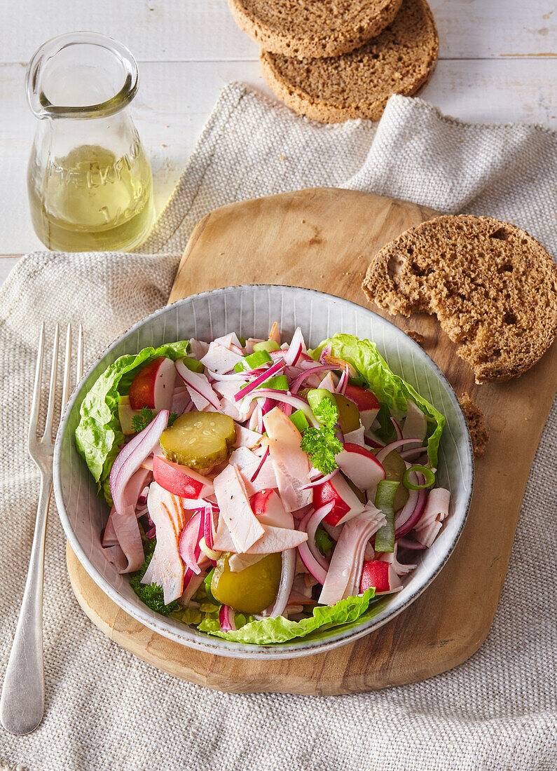 Spring salad with sausage, radishes and gherkins