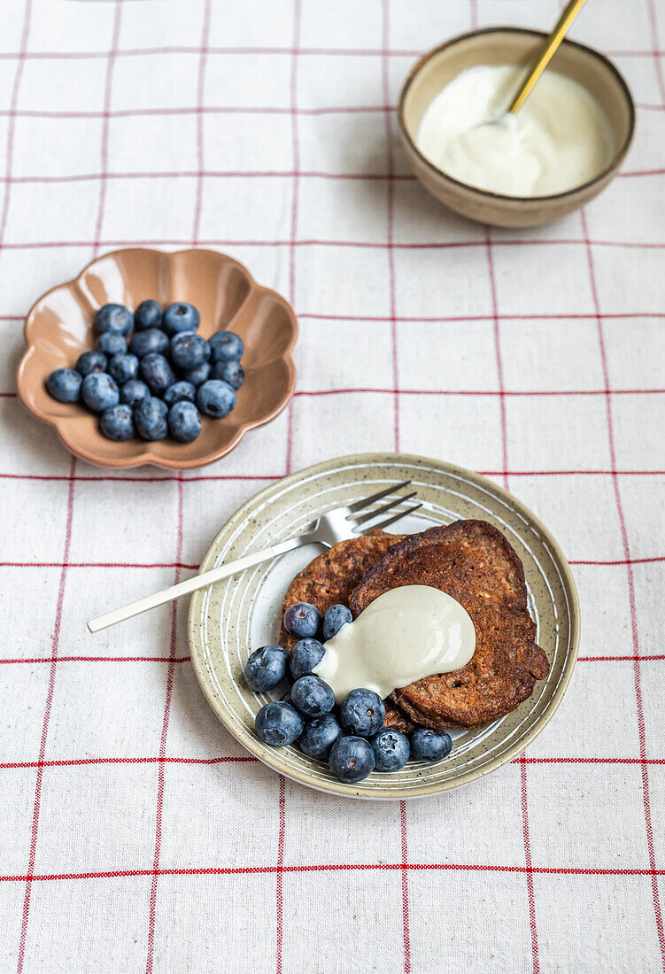 Chocolate rye pancakes with blueberries and tahini yogurt