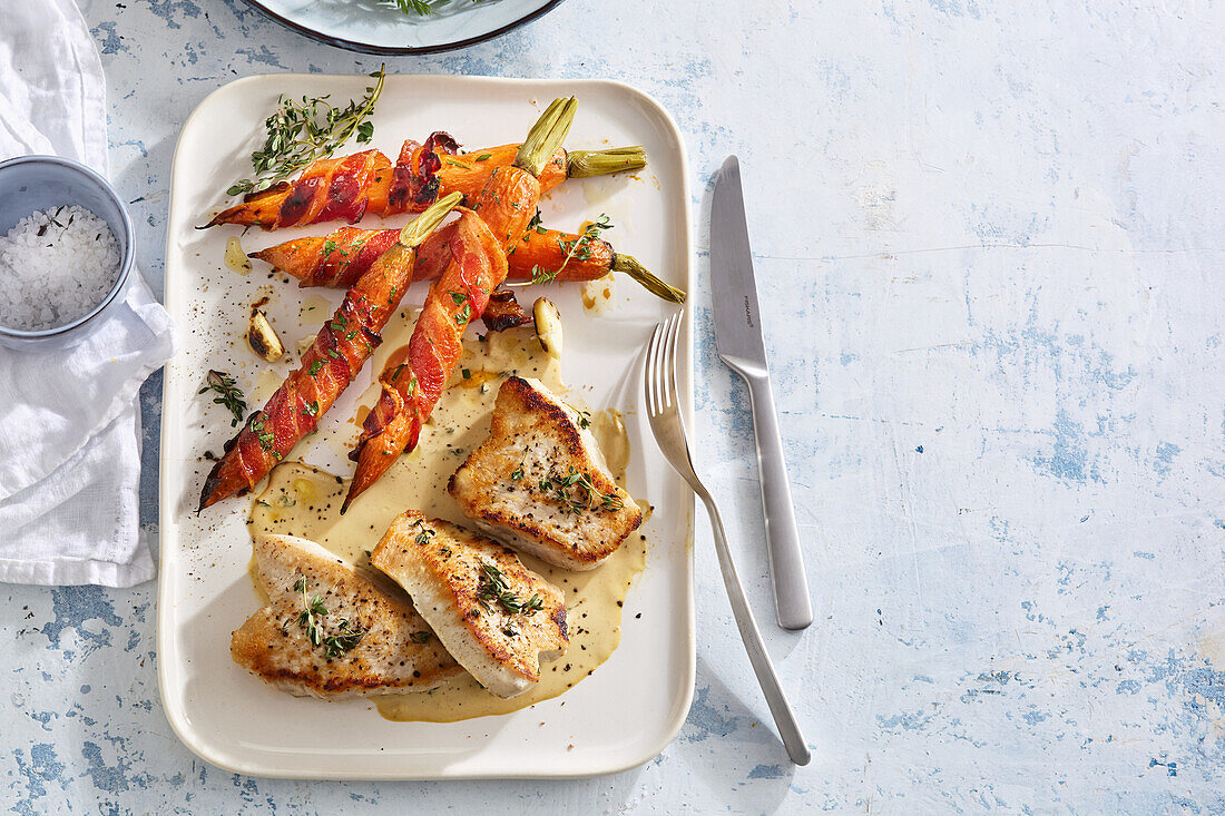 Turkey steak with glazed bacon and carrots