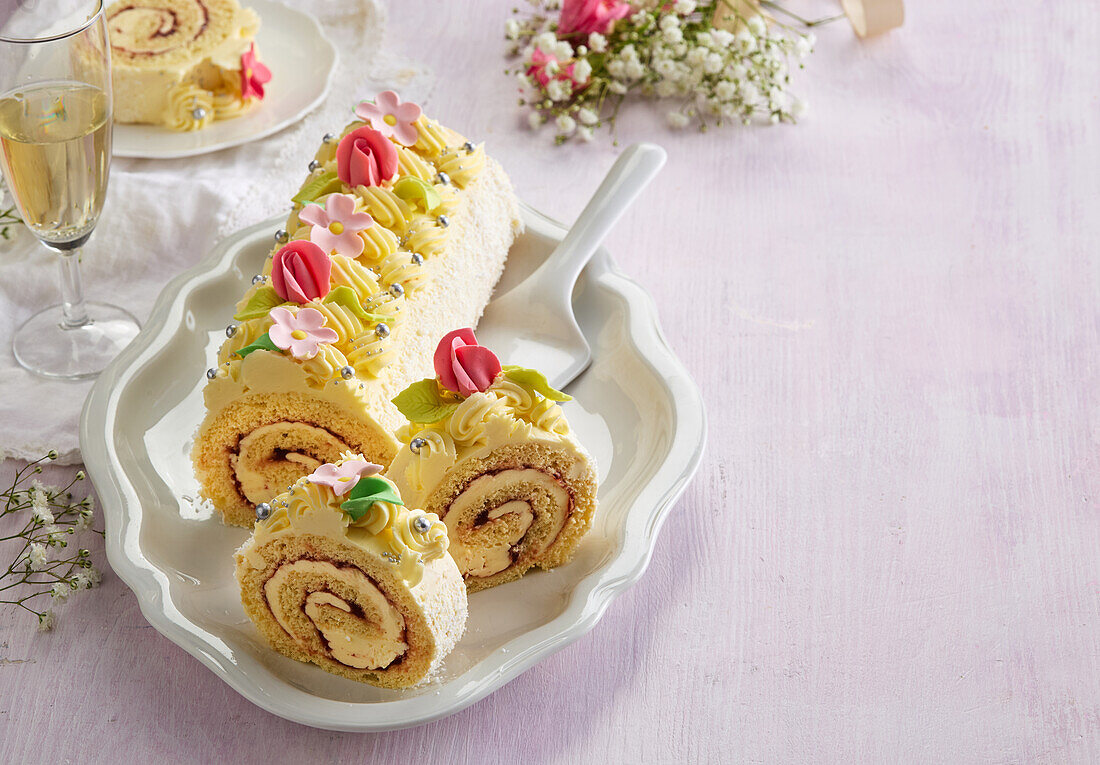 Wedding sponge roll with pudding and marzipan flowers