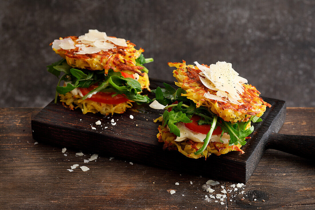 Potato pancake burger with rocket, tomato and pecorino