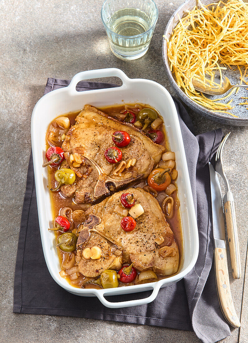 Pork chops with pickled peppers and potato straw