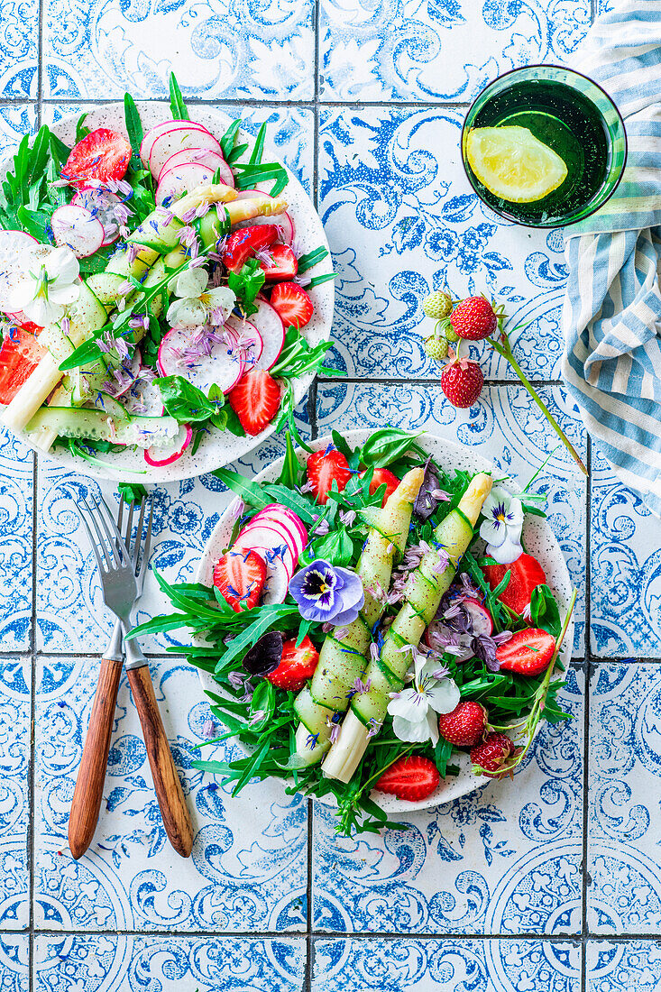 Asparagus strawberry salad with arugula and edible flowers