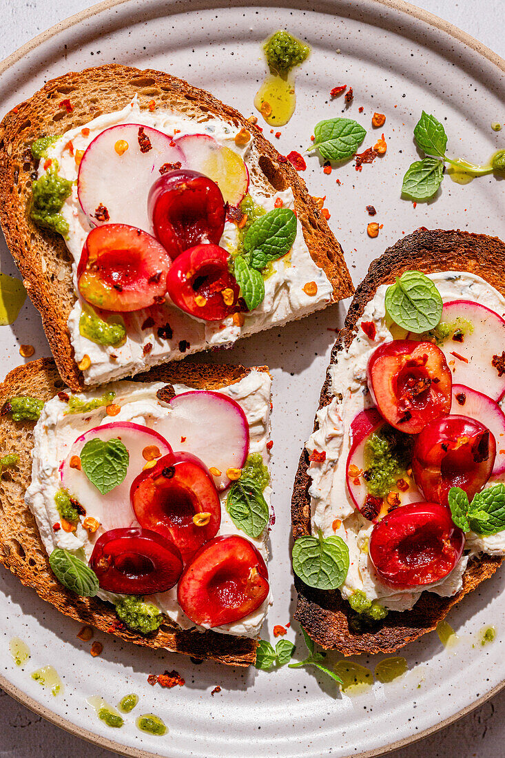 Bruschetta with cream cheese, cherries and radishes