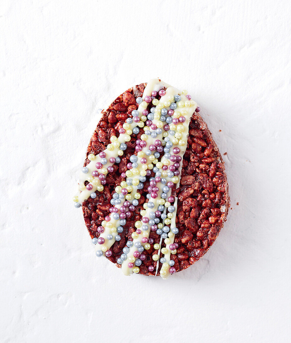 Chocolate puffed rice Easter egg with icing and sugar sprinkles