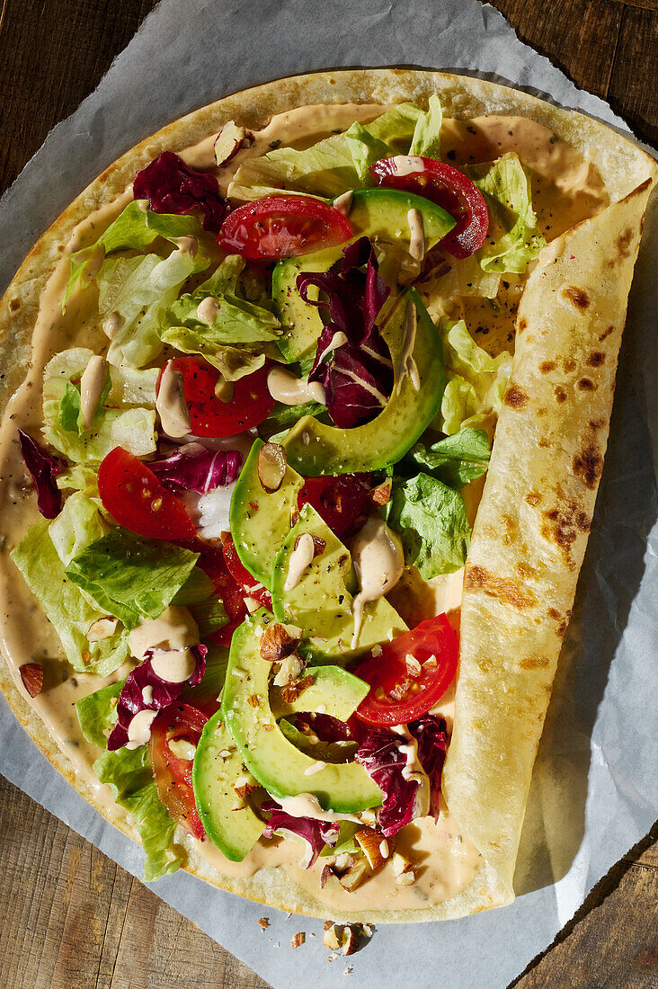 Vegetable wrap with radicchio, avocado, tomatoes and roasted almonds