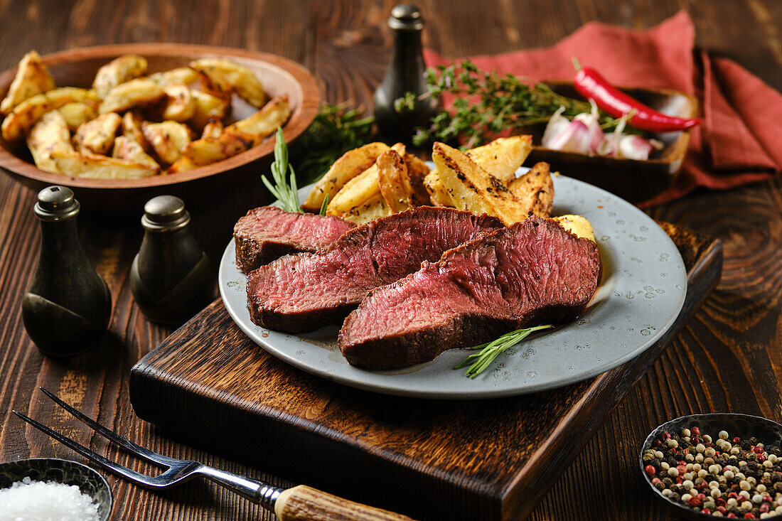 Beef steak with baked potatoes and herbs