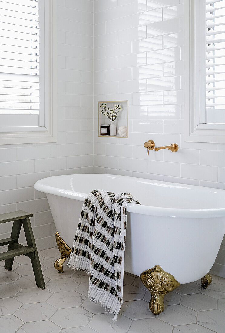 Bathtub with golden lion feet and chequered towel