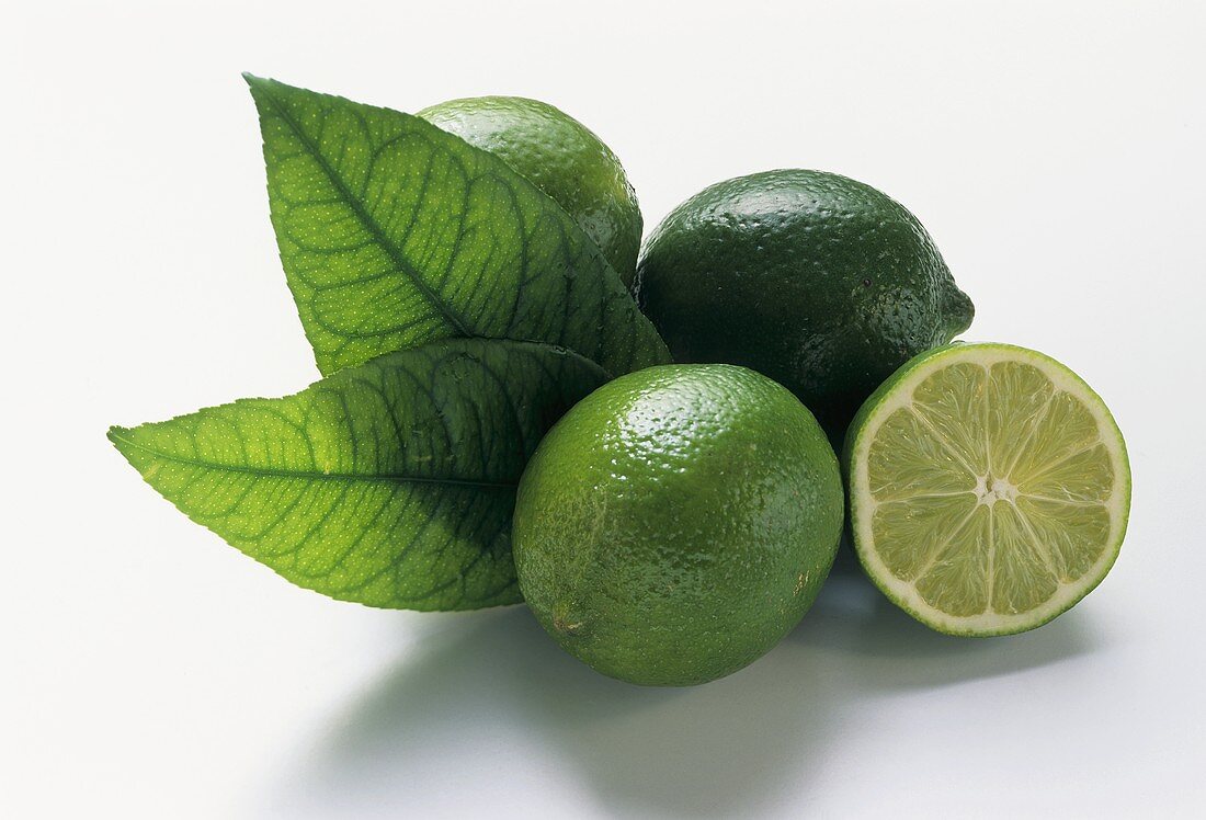 Three limes with leaves and half a lime