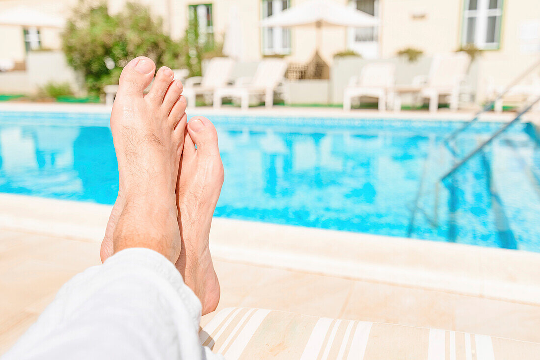 Barefoot tourist by swimming pool