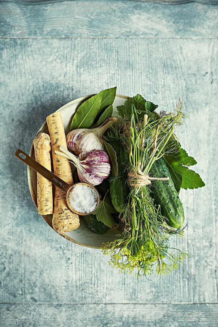 Ingredients for fermented gherkins - dill, garlic, fresh horseradish, bay leaf