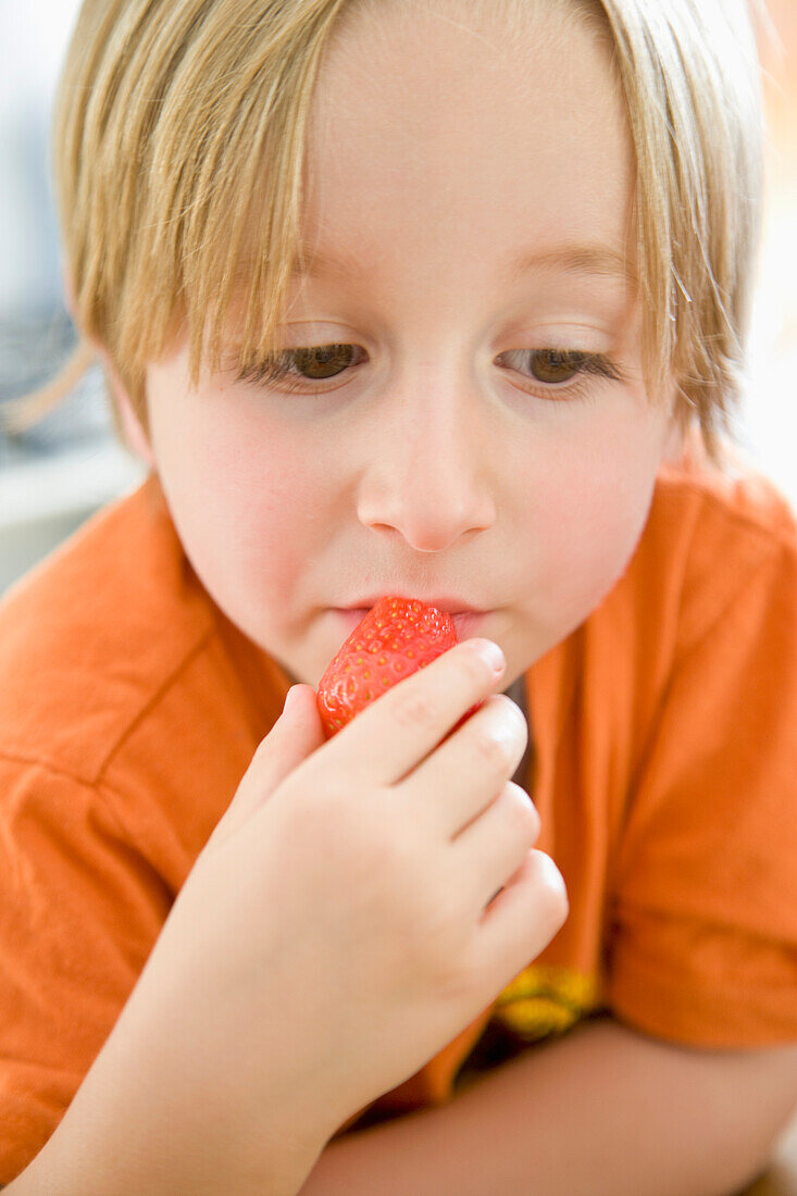 Young Boy Eating Strawberry