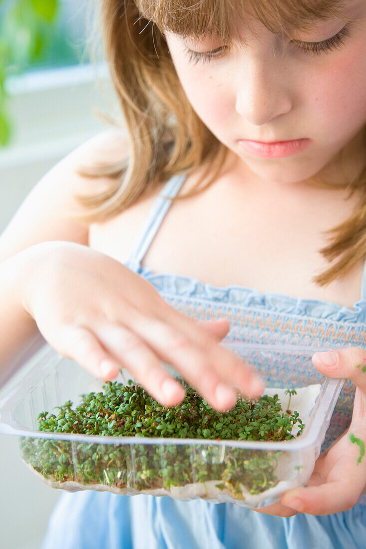 Young Girl Inspecting Watercress Seedlings