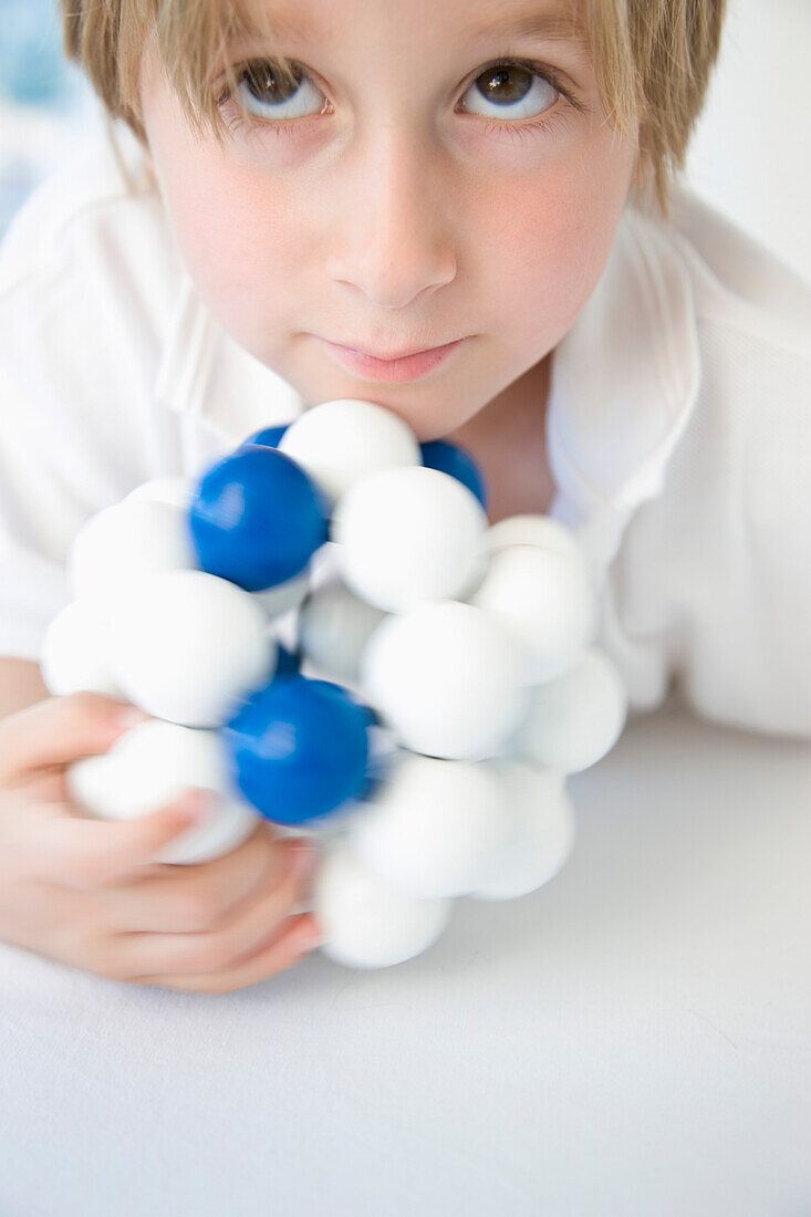 Boy Holding Atom Model